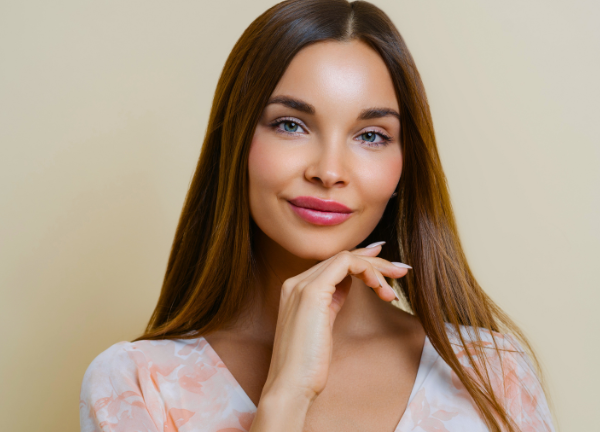 A woman holding her jawline in Omaha, NE